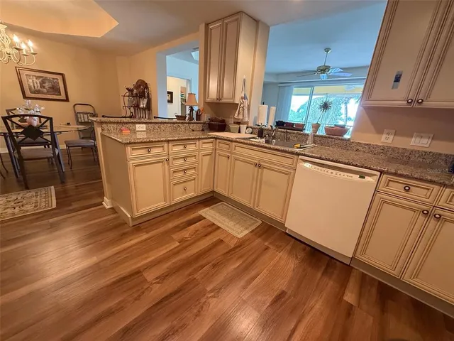 a kitchen with a sink window and cabinets