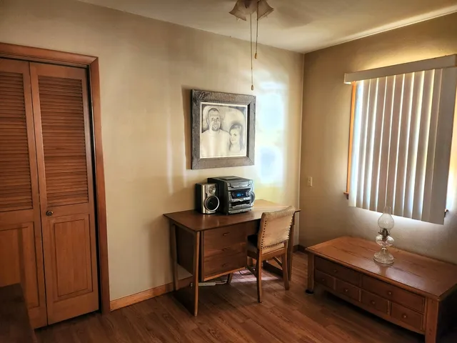 a view of a workspace with furniture and a window