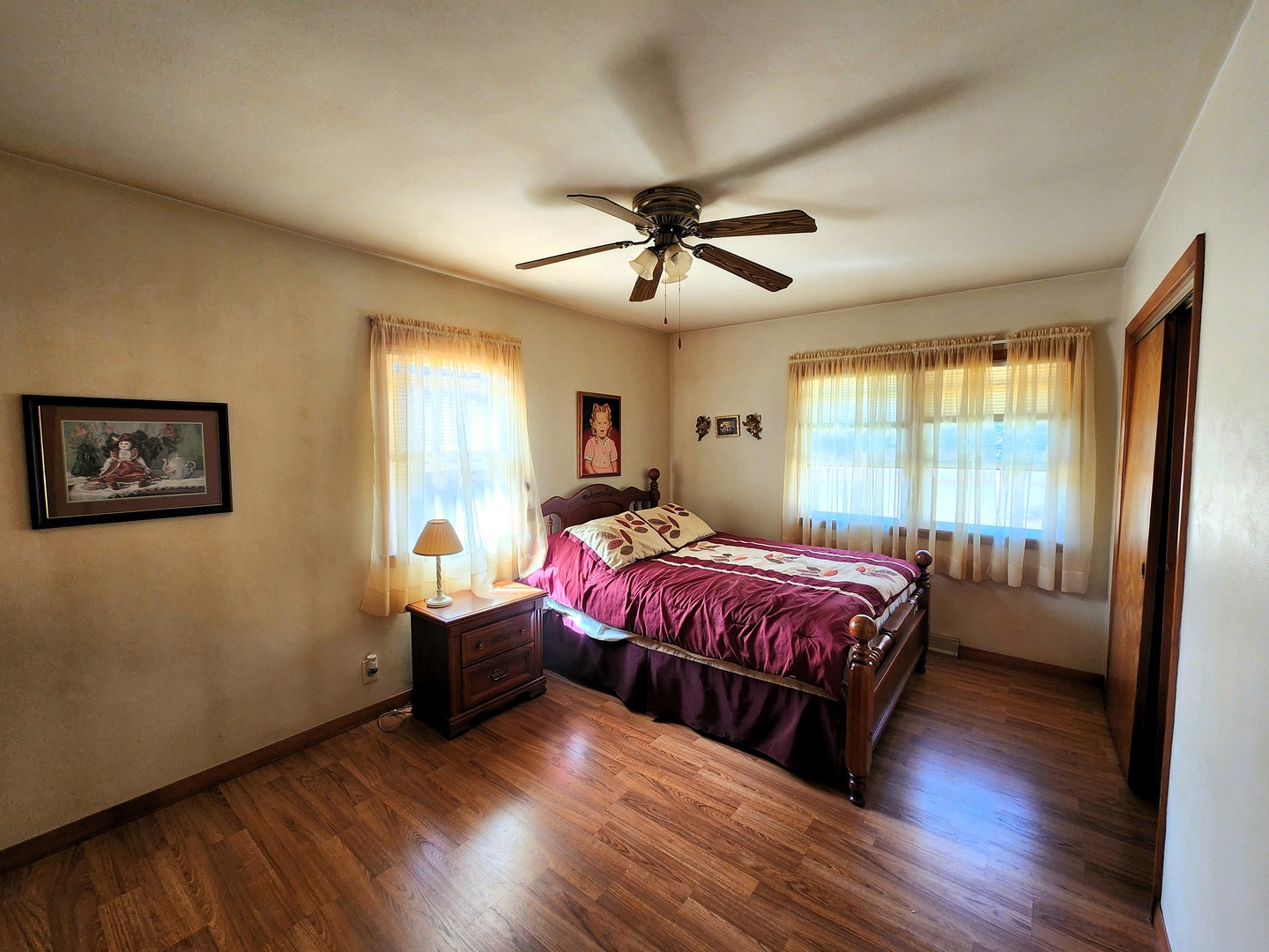 45 Locust Street Prophetstown, IL 61277 - Photo 8 of 14 a spacious bedroom with a bed and wooden floor