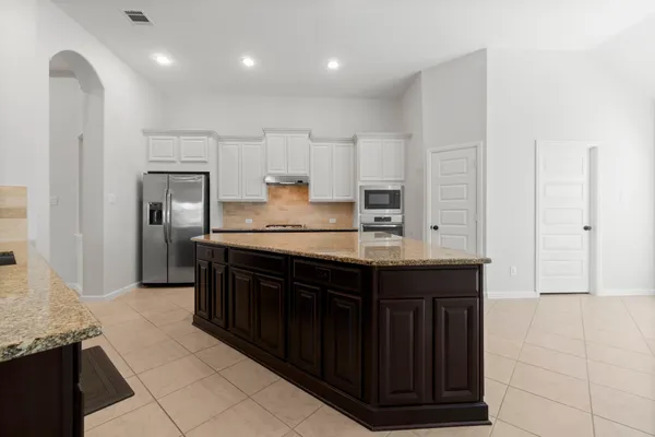 a kitchen with stainless steel appliances granite countertop a sink and cabinets