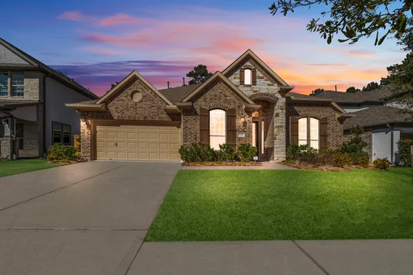 a front view of a house with a yard and garage