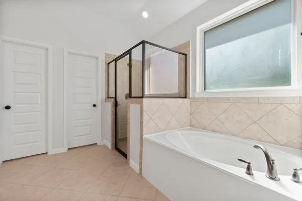 a bathroom with a bathtub and a shower