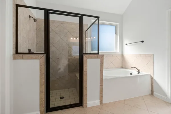 a bathroom with a bathtub and a shower