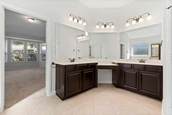 a bathroom with a sink vanity and a mirror