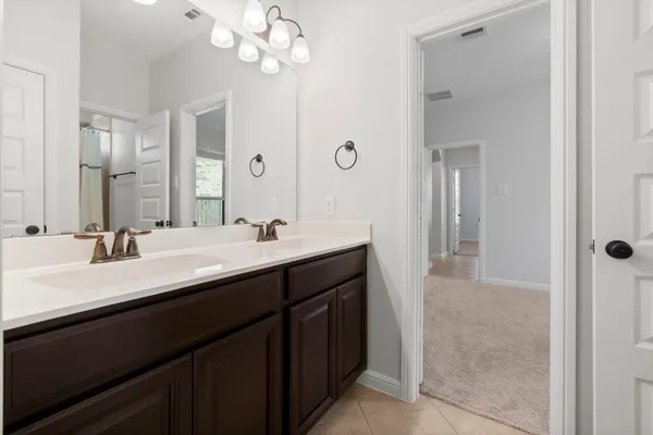 a bathroom with a sink double vanity and a mirror