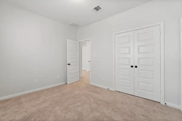 an empty room with closet area