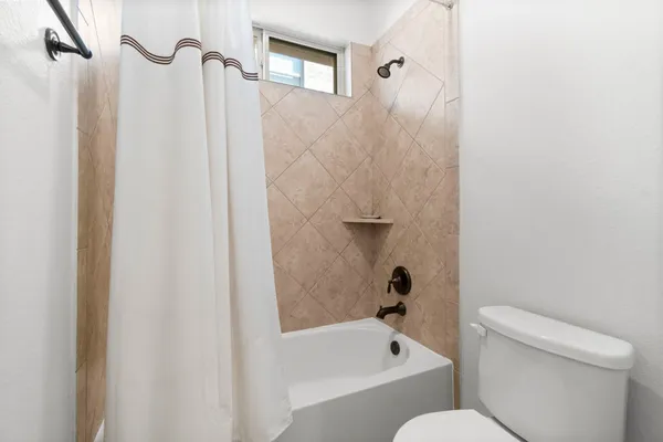 a bathroom with a toilet and a bathtub