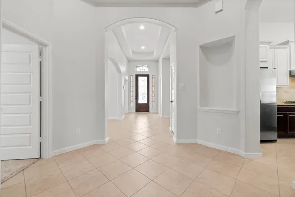 a view of a hallway with closet and a bathroom