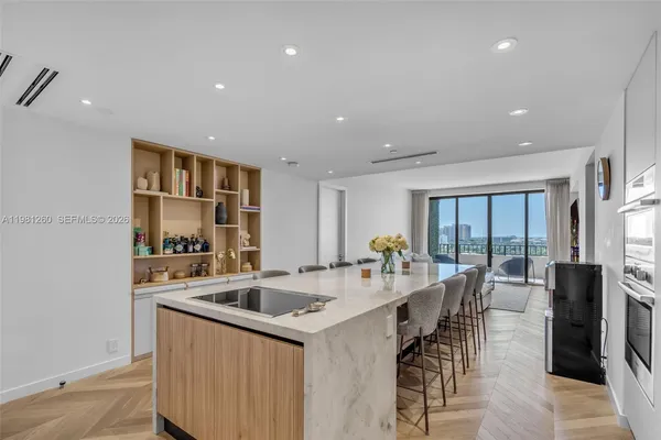 a kitchen with stainless steel appliances granite countertop a sink a stove and a refrigerator