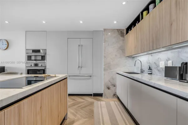 a kitchen with granite countertop a sink stove and cabinets