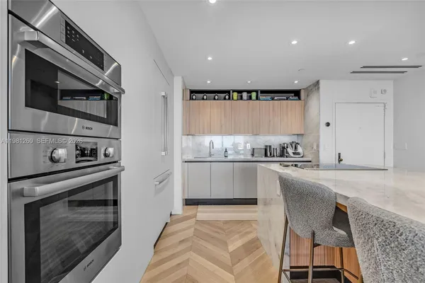 a kitchen with stainless steel appliances granite countertop a stove a sink and a refrigerator