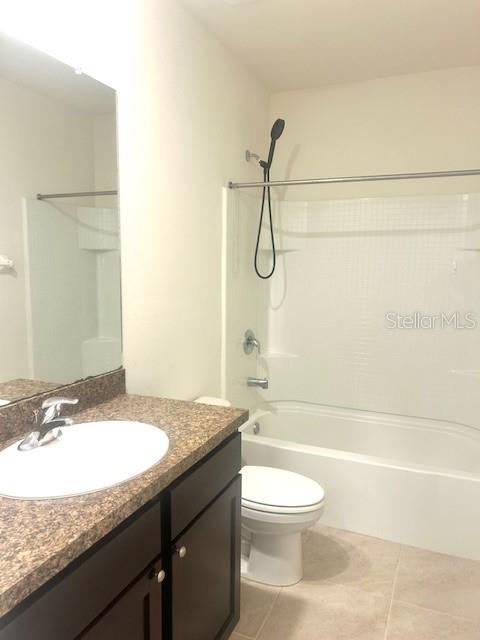 8640 Milestone Drive Sarasota, FL 34238 - Photo 13 of 18 a bathroom with a granite countertop bathtub shower sink vanity and toilet