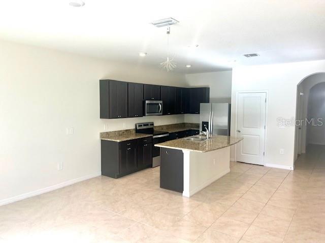 8640 Milestone Drive Sarasota, FL 34238 - Photo 17 of 18 a large kitchen with cabinets and stainless steel appliances