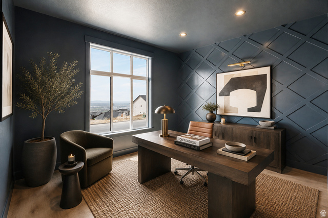 692 East Mountain Road North Ogden, UT 84414 - Photo 17 of 35 Spacious room featuring a large multi-pane window, decorative accent wall with diamond paneling, recessed ceiling lighting, and wood-finish flooring