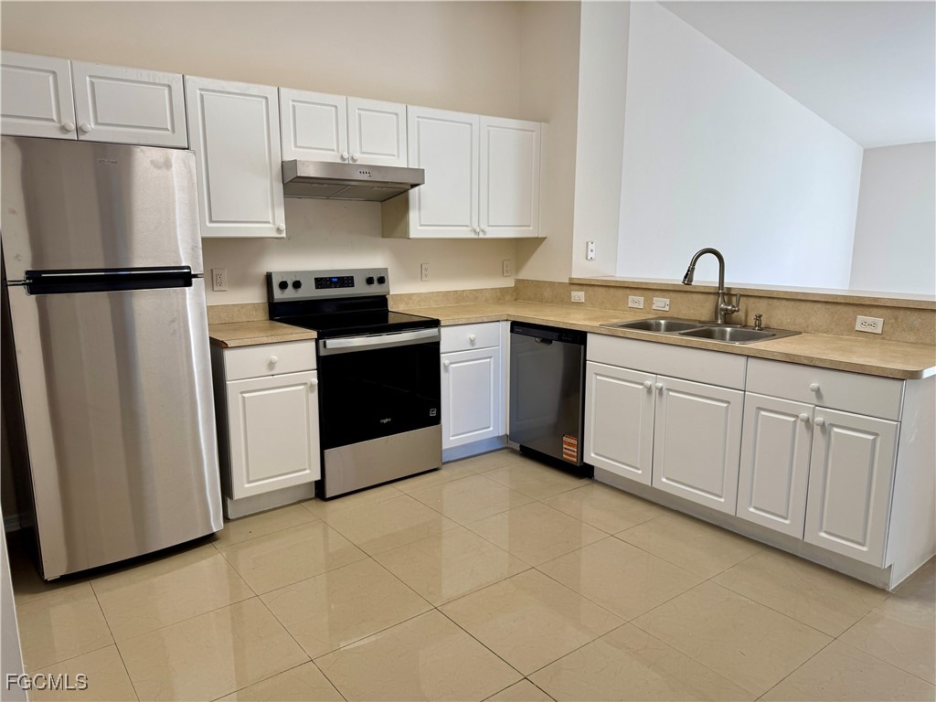 10743 Robinson Street Fort Myers, FL 33908 - Photo 3 of 11 a kitchen with a sink and a refrigerator