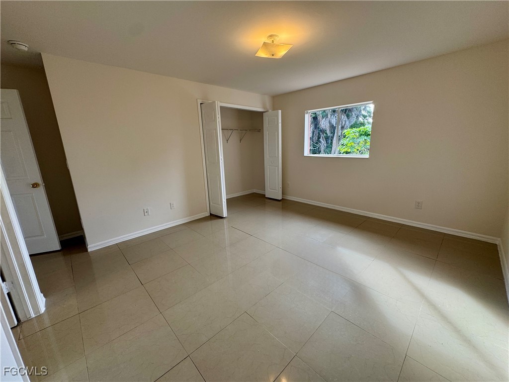 10743 Robinson Street Fort Myers, FL 33908 - Photo 4 of 11 an empty room with windows