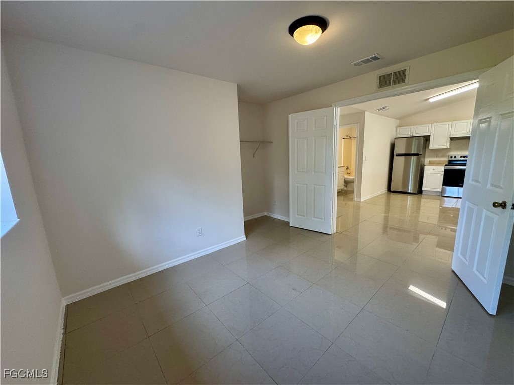 10743 Robinson Street Fort Myers, FL 33908 - Photo 6 of 11 wooden floor in an empty room