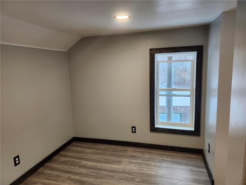 532 Washington Street Parker, PA 16049 - Photo 13 of 19 an empty room with wooden floor and windows