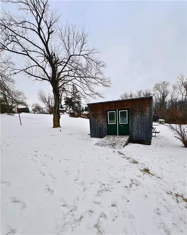532 Washington Street Parker, PA 16049 - Photo 18 of 19 a front view of a house with a yard covered in snow