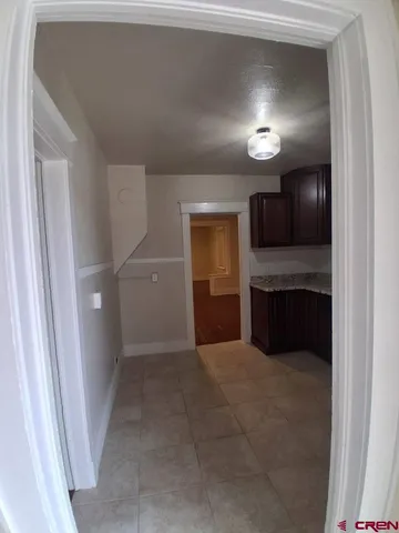 a view of kitchen and refrigerator