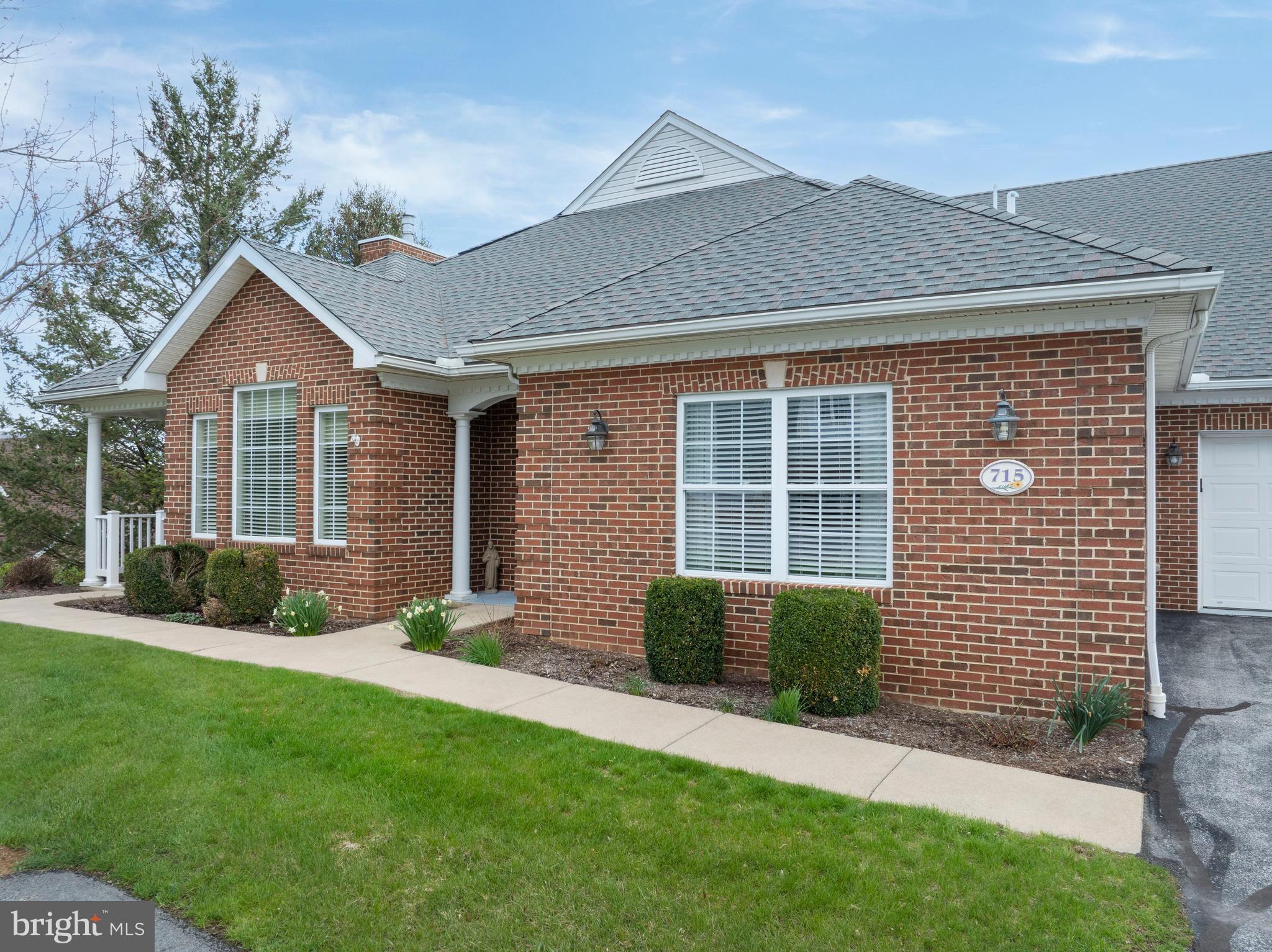 3291 Shellers Bend, Unit 715 State College, PA 16801 - Photo 1 of 45 a front view of a house with a garden and plants