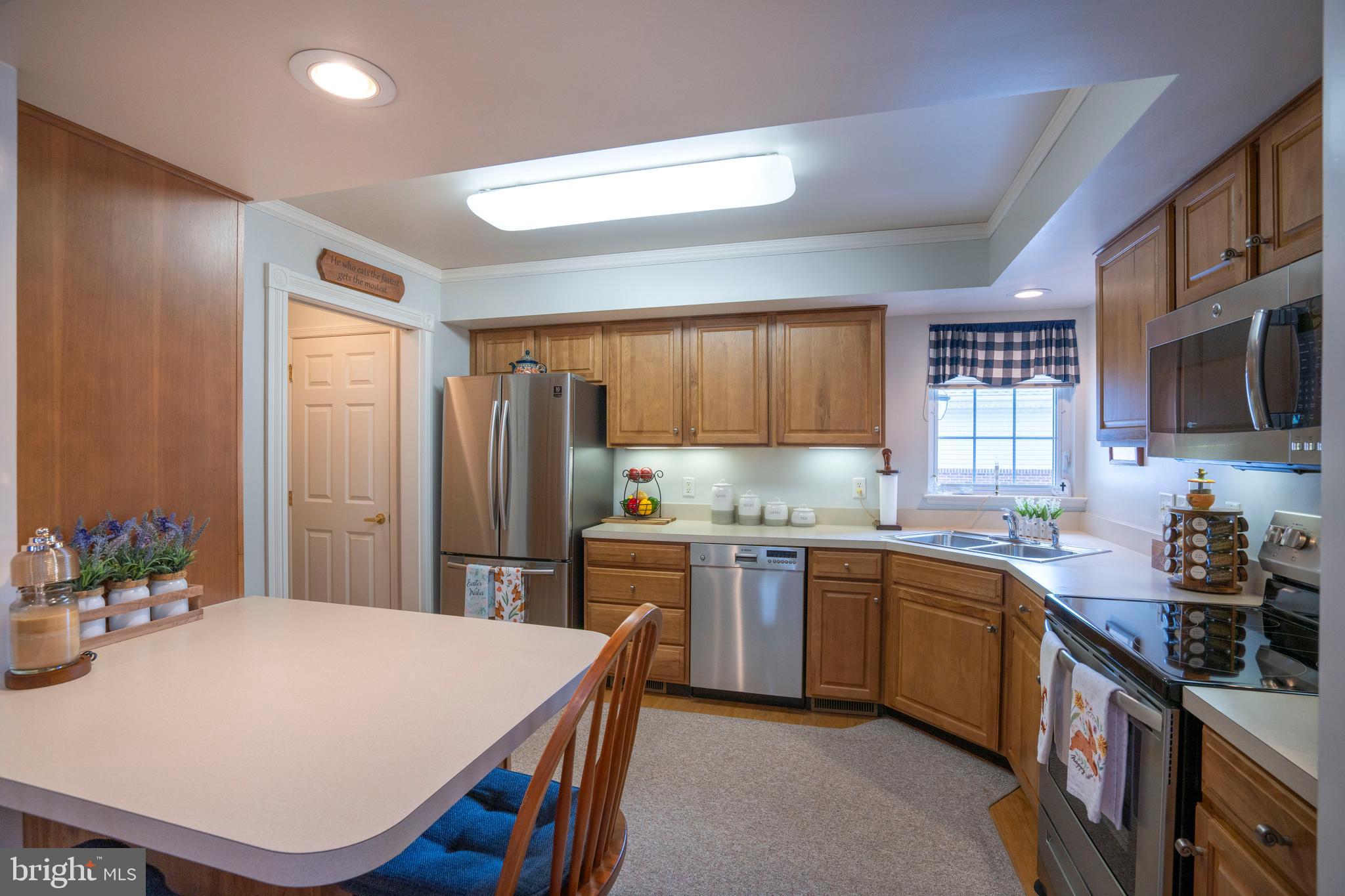 3291 Shellers Bend, Unit 715 State College, PA 16801 - Photo 11 of 45 a kitchen with stainless steel appliances granite countertop a sink stove and refrigerator