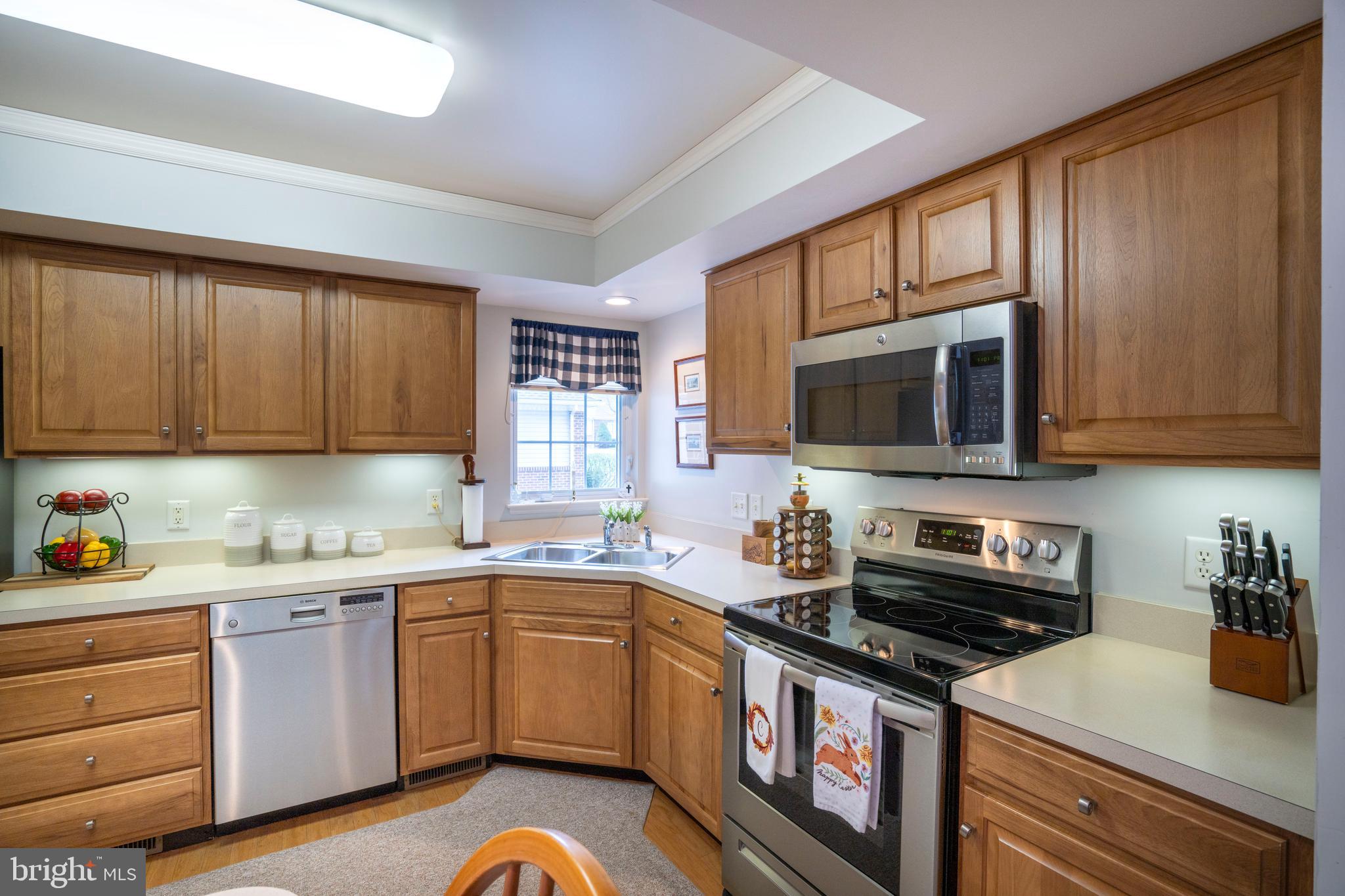 3291 Shellers Bend, Unit 715 State College, PA 16801 - Photo 12 of 45 a kitchen with stainless steel appliances a stove a sink a stove cabinets and a microwave