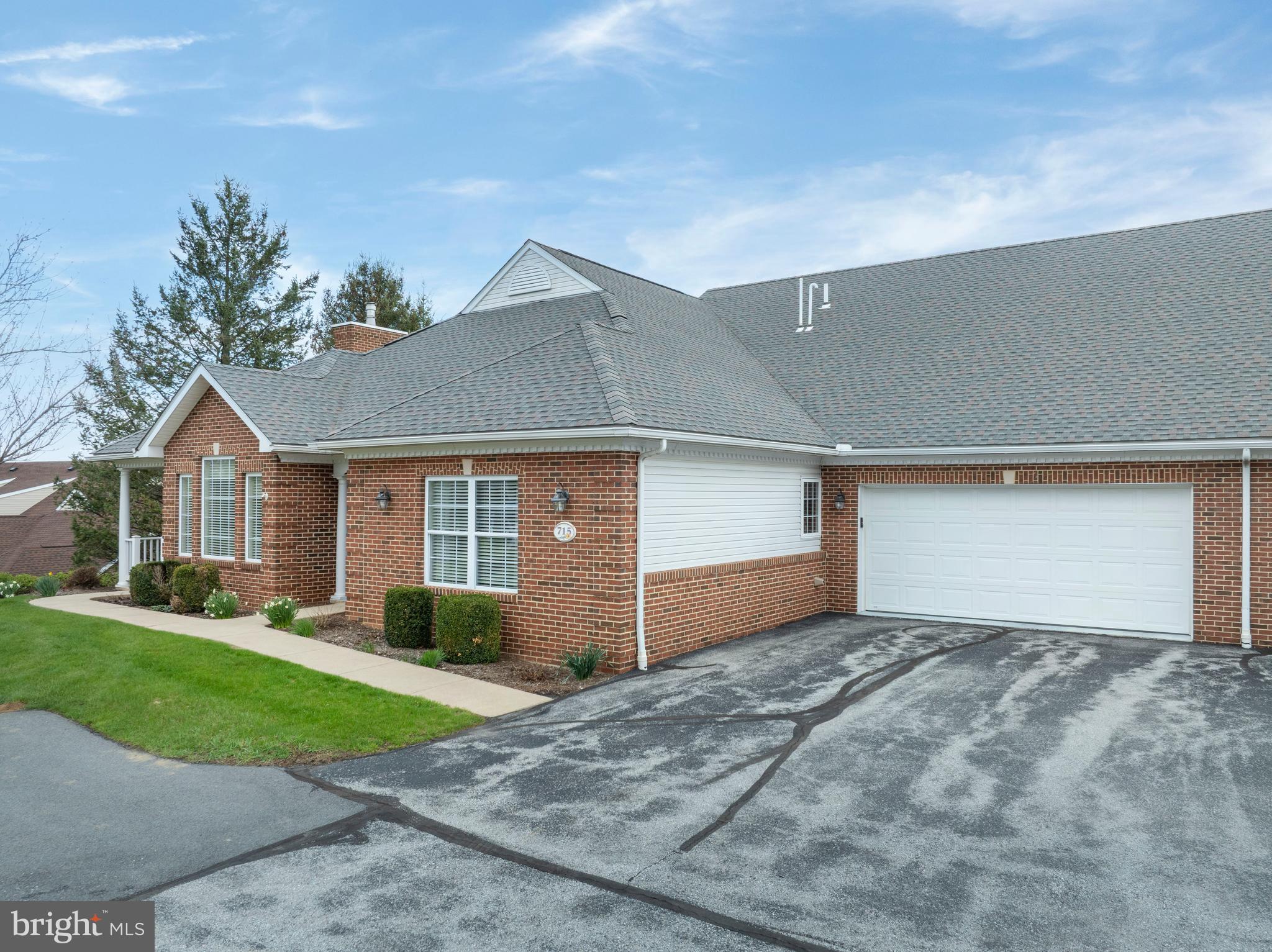 3291 Shellers Bend, Unit 715 State College, PA 16801 - Photo 2 of 45 a front view of a house with a yard and garage