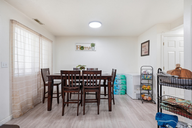 203 North Geneva Road, Unit 10 Provo, UT 84601 - Photo 6 of 30 Dining area featuring wood-finish flooring, white walls, and a visible ceiling light fixture