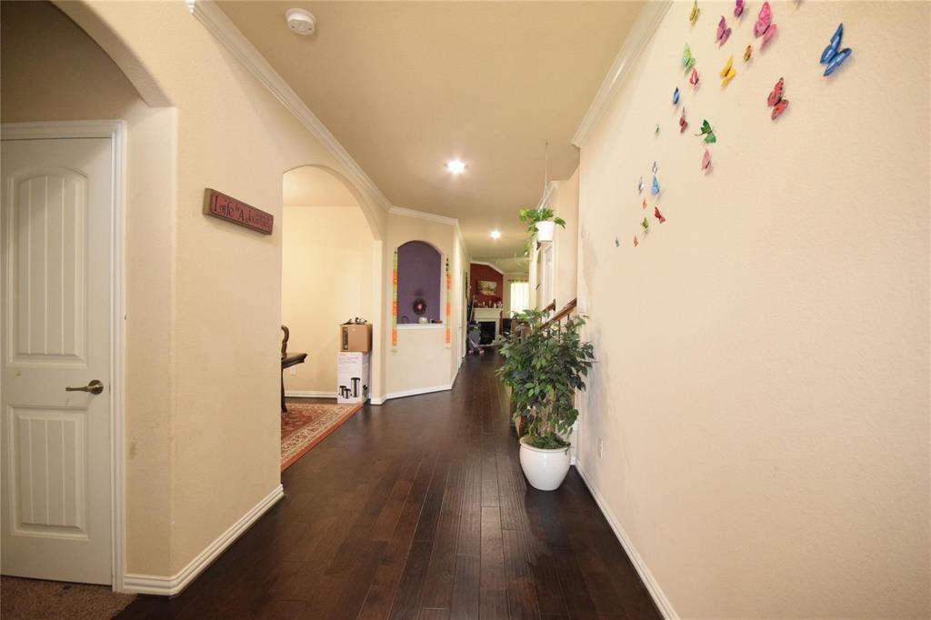 12421 Hitch Rack Way McKinney, TX 75071 - Photo 3 of 21 a view of a hallway with wooden floor and a potted plant