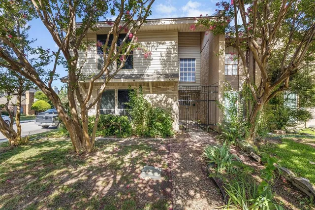 a view of a house with a tree