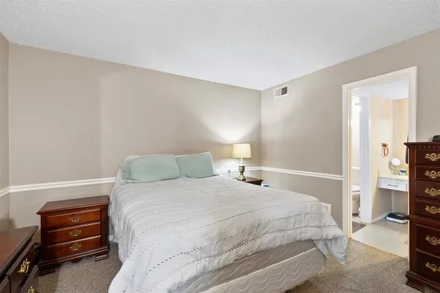 a bedroom with a bed and a tv on the dresser