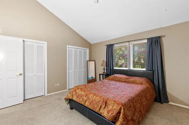 a bed sitting in a bedroom next to a window