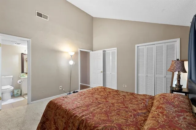 a bedroom with a bed and a mirror