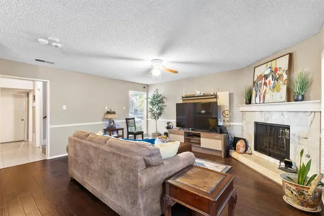 a living room with furniture a fireplace and a flat screen tv