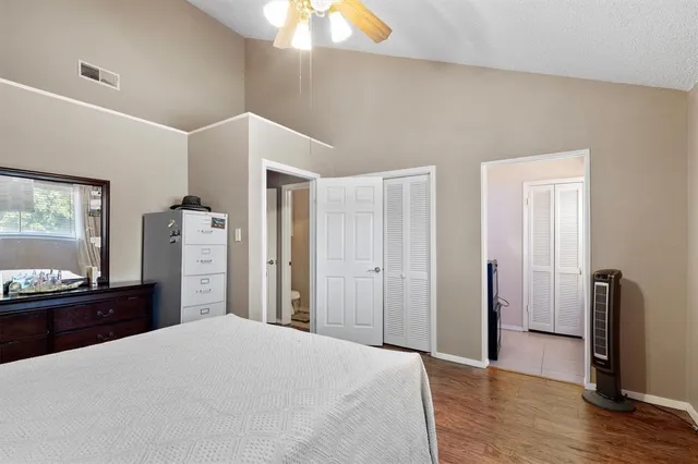 a bedroom with a bed and wooden floor