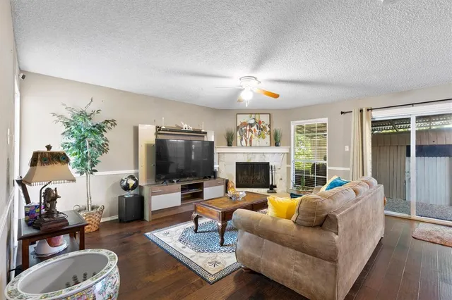 a living room with furniture a fireplace and a flat screen tv