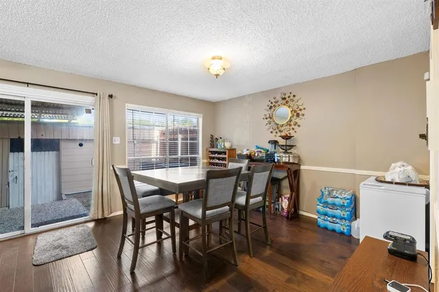 a view of a dining room with furniture and a chandelier
