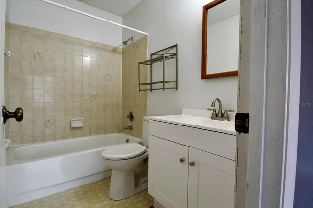 a bathroom with a white toilet sitting next to a bathroom sink and a shower