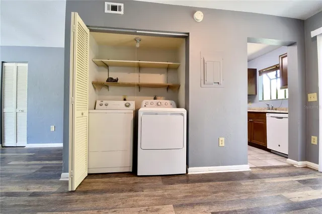 a utility room with cabinets washer and dryer