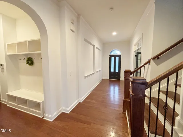 a view of a livingroom with hardwood floor and a kitchen
