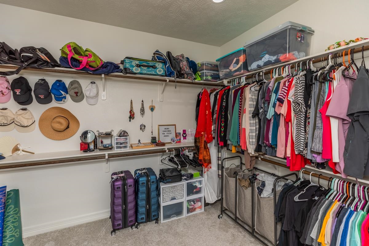 314 Long Leaf Street Silsbee, TX 77656 - Photo 19 of 31 a view of walk in closet with clothes and shoes