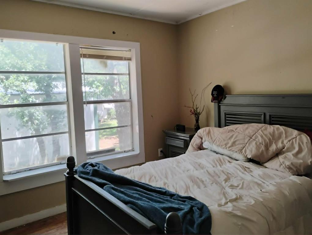 763 Frontier Street Bowie, TX 76230 - Photo 6 of 28 a bedroom with a bed and a window