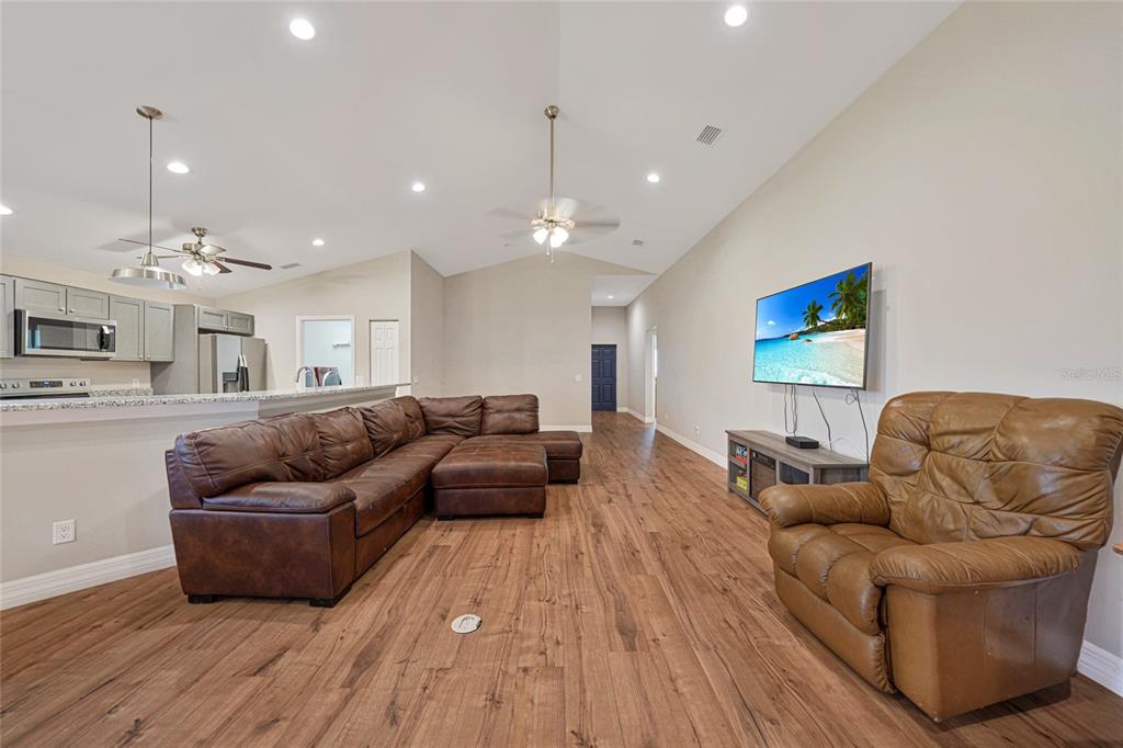 27234 Adams Street Punta Gorda, FL 33983 - Photo 11 of 29 a living room with furniture and a chandelier