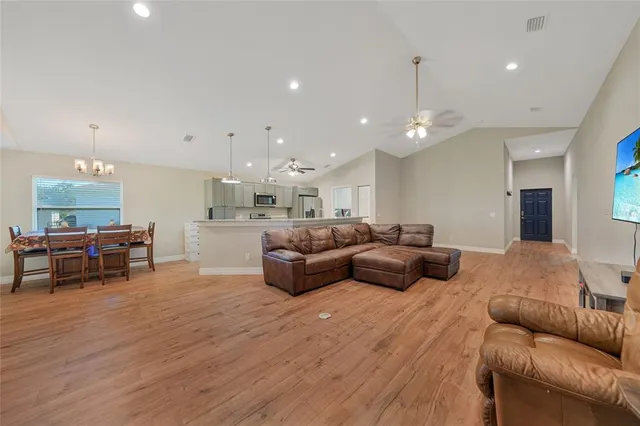 a living room with furniture and kitchen view