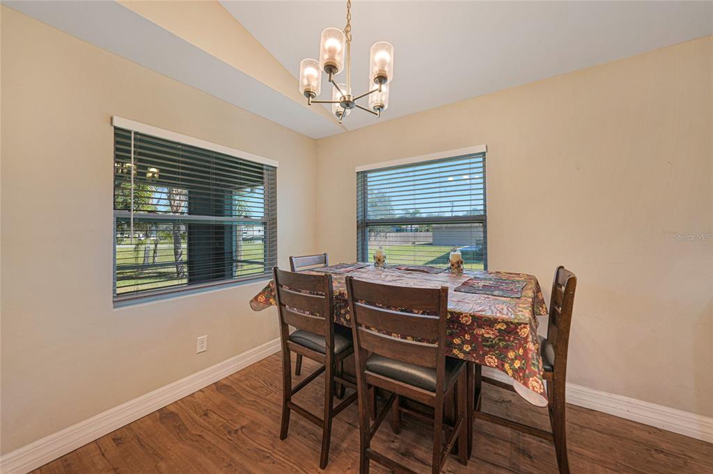 27234 Adams Street Punta Gorda, FL 33983 - Photo 13 of 29 a view of a dining room with furniture window and wooden floor