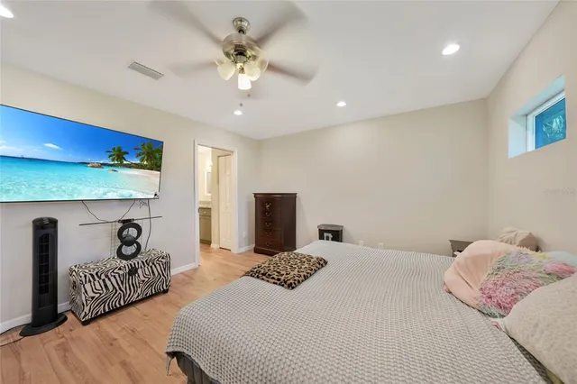 a bedroom with bed and a chandelier