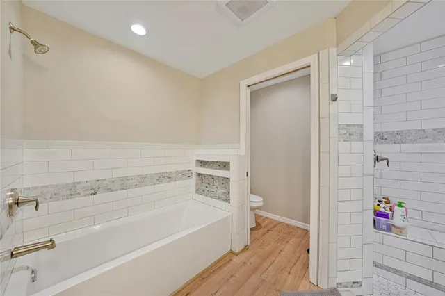 a bathroom with a bathtub and a shower