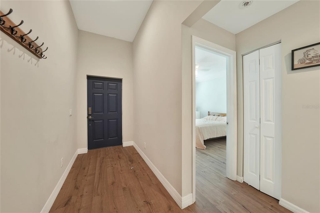 27234 Adams Street Punta Gorda, FL 33983 - Photo 5 of 29 a view of a hallway with wooden floor and a bathroom