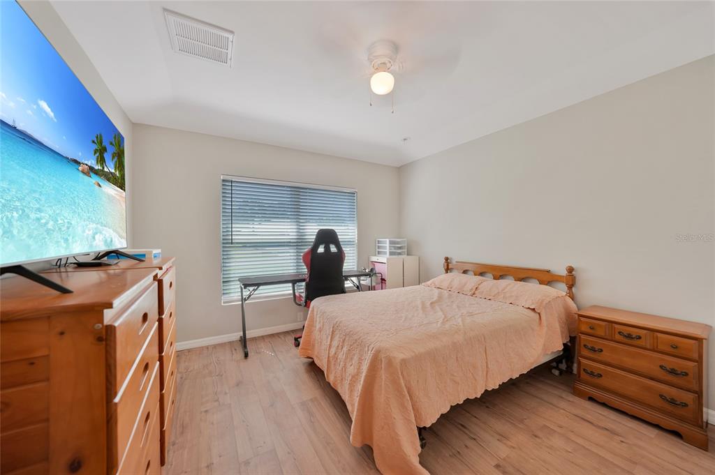 27234 Adams Street Punta Gorda, FL 33983 - Photo 6 of 29 a bedroom with a bed and a dresser